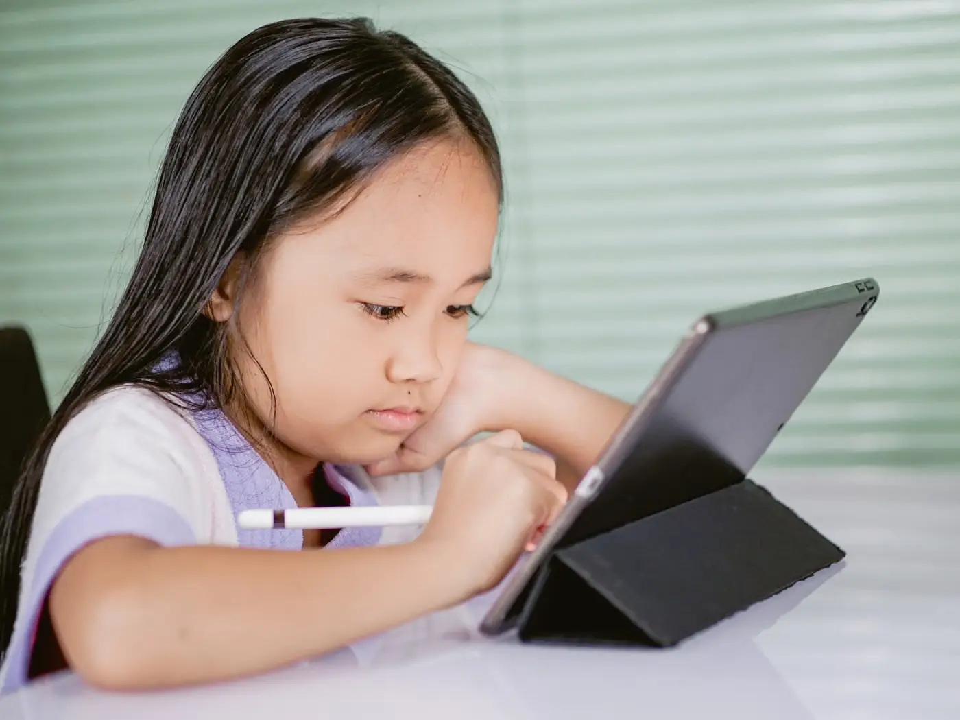 Child using a tablet for a learning app