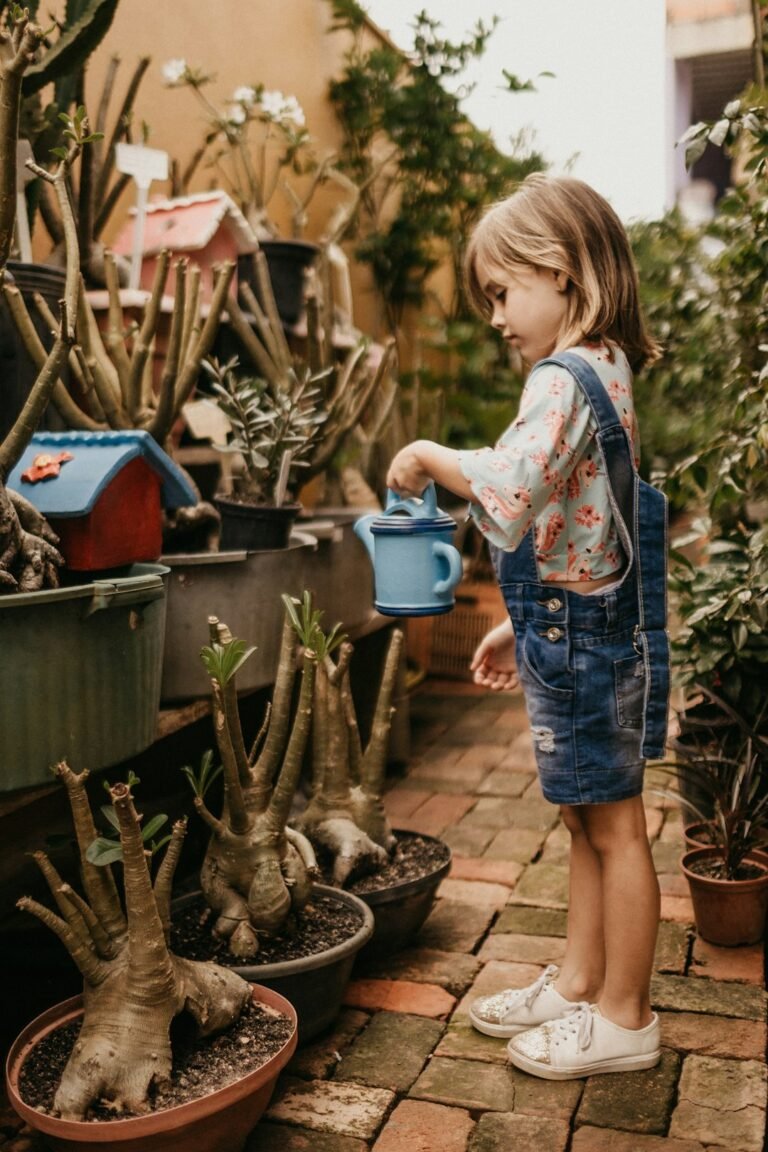 Child watering a plant as a household chore