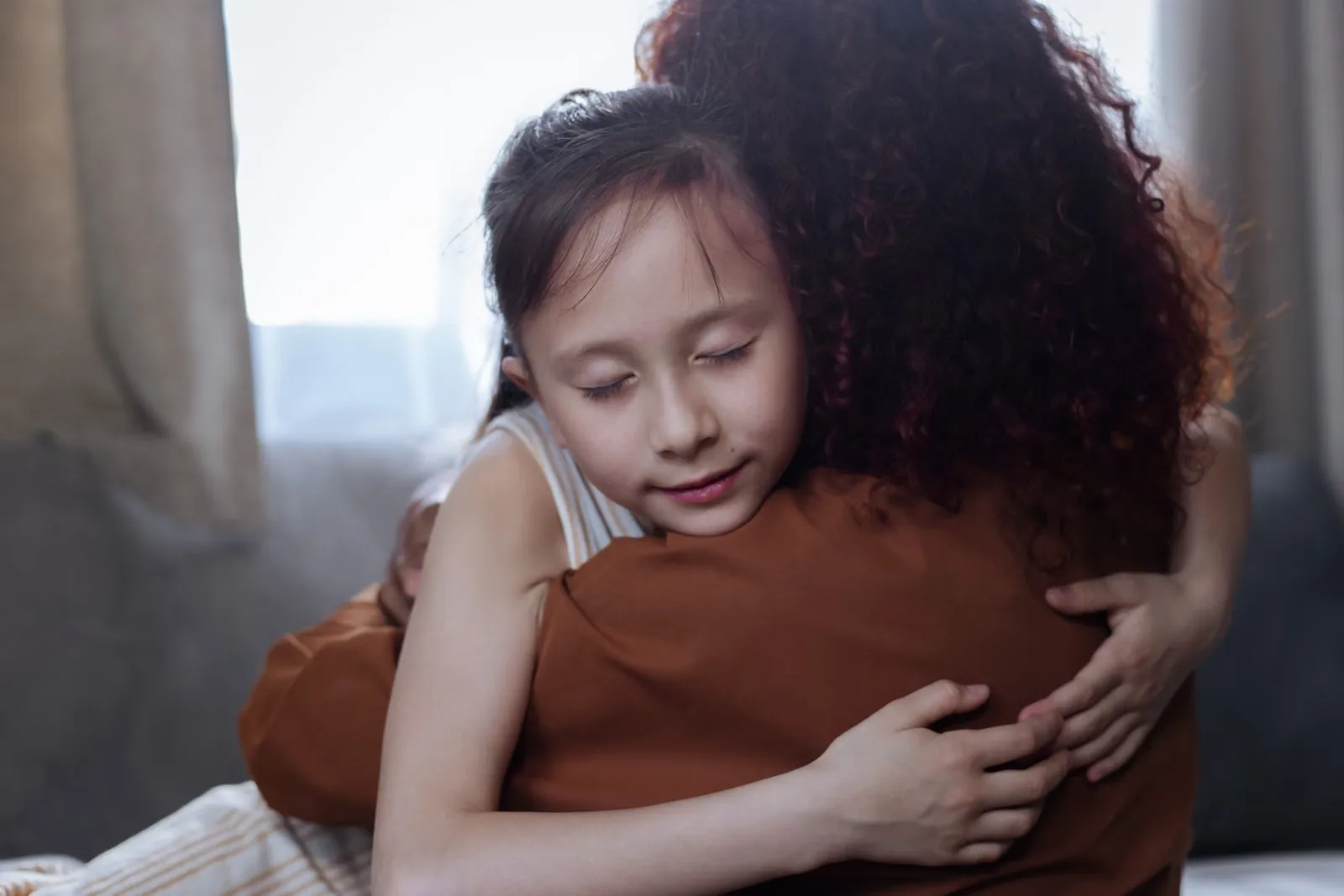 Parent comforting and hugging a child