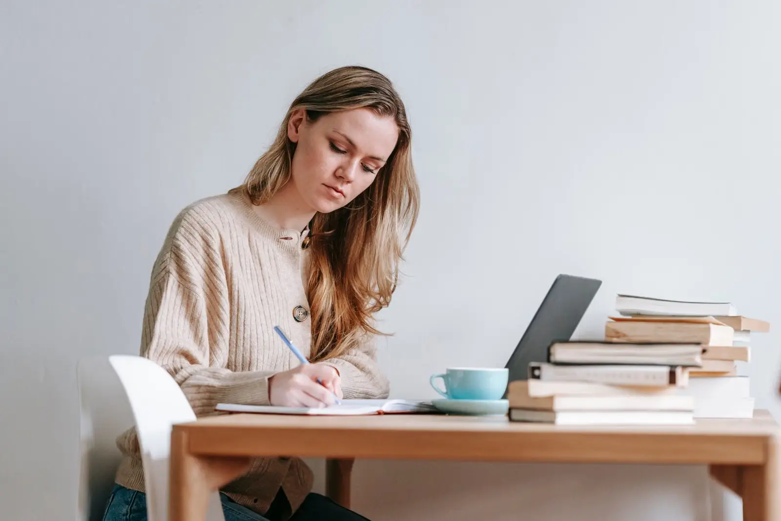 Parent writing notes at a desk
