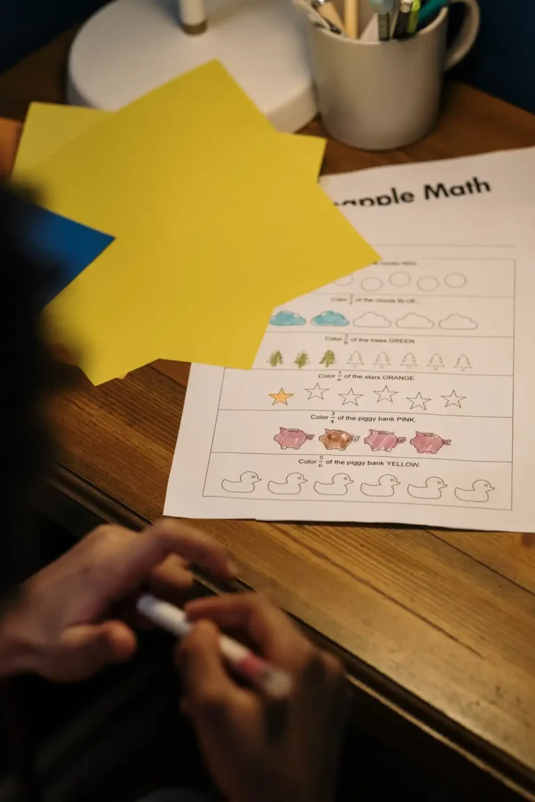 Colorful printable worksheet on a wooden desk with craft paper and a child coloring, representing free downloadable resources